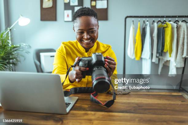 photographer holding a dslr camera in her hand - average photo editing by professional photographers stock pictures, royalty-free photos & images