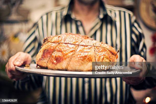 man holding roast turkey - man tray food holding stockfoto's en -beelden
