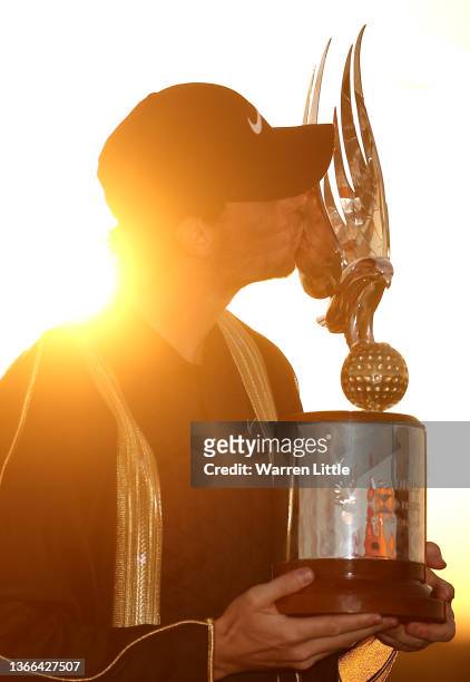 Thomas Pieters of Belgium kisses the trophy after winning the Abu Dhabi HSBC Championship at Yas Links Golf Course on January 23, 2022 in Abu Dhabi,...