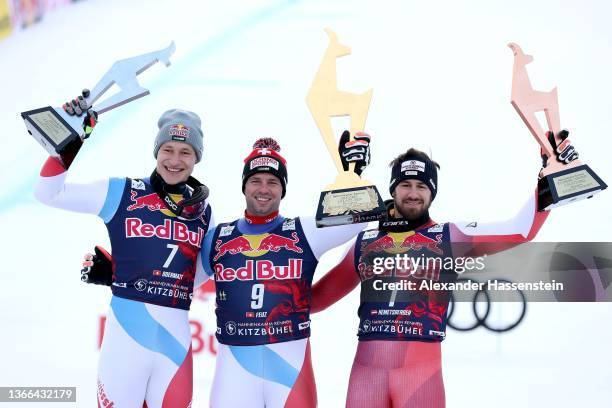 Marco Odermatt of Switzerland , Beat Feuz of Switzerland and Daniel Hemetsberger of Austria celebrate at the medal ceremony for the Audi FIS Alpine...