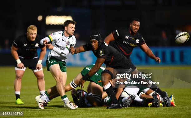 Ben White of London Irish passes under pressure from Maro Itoje of Saracens during the EPCR Challenge Cup match between Saracens and London Irish at...