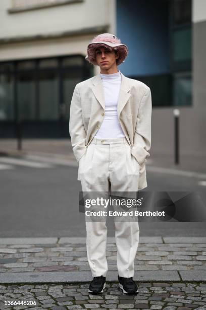 Guest wears a pale gray suede with pale pink fluffy strap bob, a white high neck t-shirt, a beige linen blazer jacket, matching beige high waist suit...