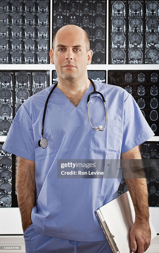 Doctor in scrubs, portrait with mri scans