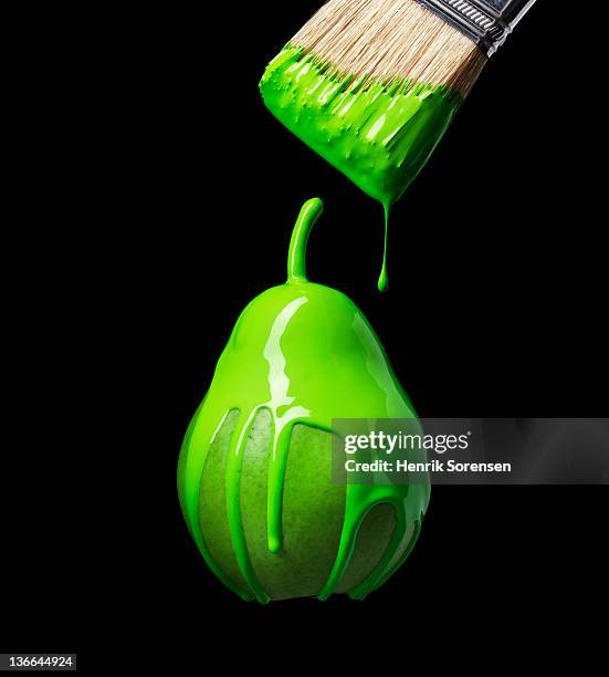 green pear with green paint - genetically modified food stock pictures, royalty-free photos & images