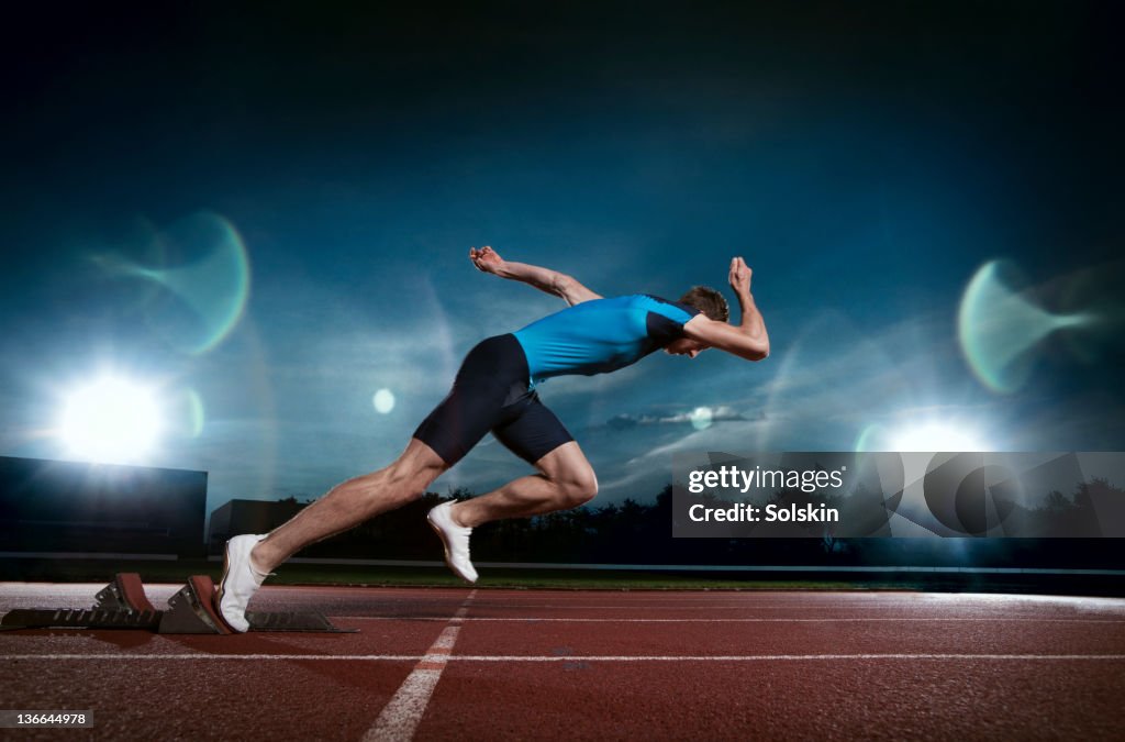 Track and field sprinter coming out of blocks