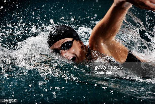 female swimmer doing crawl strokes - freestyle swimming stock pictures, royalty-free photos & images