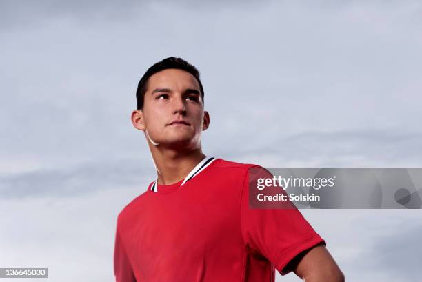 portrait of male soccer player - portrait looking over shoulder stock pictures, royalty-free photos & images