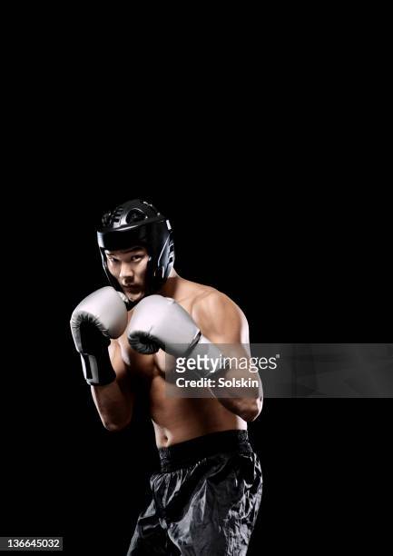 kickboxer man getting ready to fight - kickboxing gloves stock pictures, royalty-free photos & images