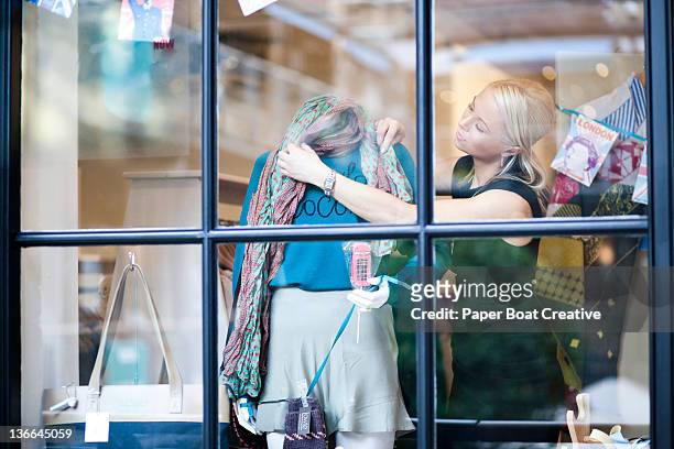 fashion designer dressing  up her shop front - europeo del norte fotografías e imágenes de stock
