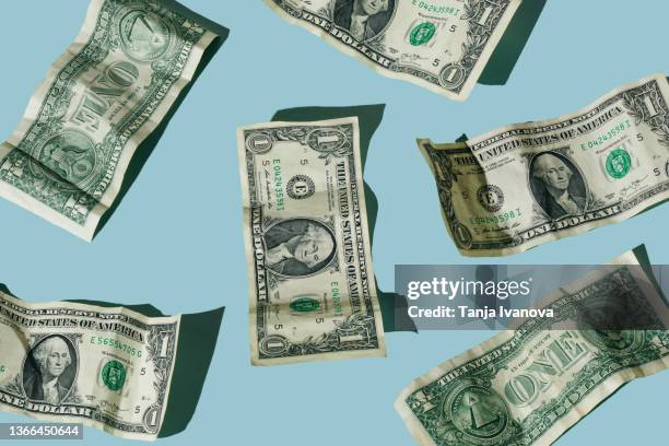 crumpled one dollar bills on blue background - banconota da 1 dollaro statunitense foto e immagini stock
