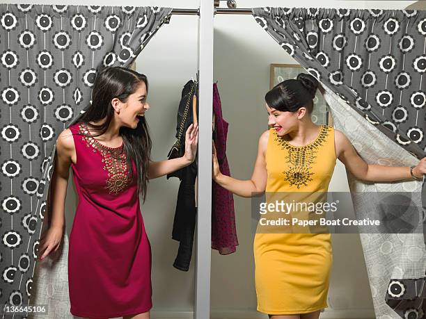 friends coming out of changing room in same dress - women dressed the same stock pictures, royalty-free photos & images