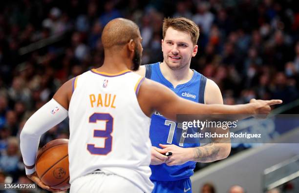 Chris Paul of the Phoenix Suns talks with Luka Doncic of the Dallas Mavericks on the court at American Airlines Center on January 20, 2022 in Dallas,...