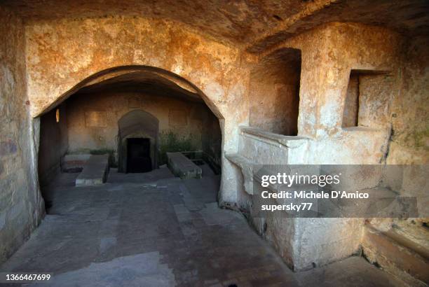 the interior of a previously inhabited cave in sasso caveoso, matera - stone house interior stock pictures, royalty-free photos & images