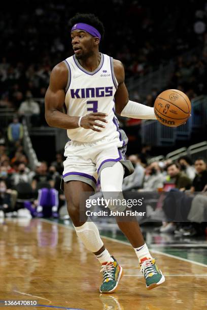 Terence Davis of the Sacramento Kings dribbles the basketball up court during the second half of the game against the Milwaukee Bucks at Fiserv Forum...