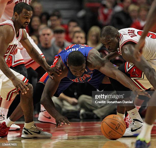 Jason Maxiell of the Detroit Pistons tries to recover a loose ball between John Lucas III and Loul Deng of the Chicago Bulls at the United Center on...