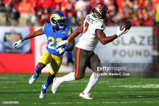 Leonard Fournette of the Tampa Bay Buccaneers catches the ball as David Long of the Los Angeles Rams defends in the second quarter in the NFC...