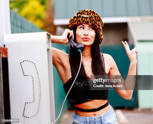 90s woman talking on payphone, cool woman saying goodbye with attitude - leopard print stock pictures, royalty-free photos & images
