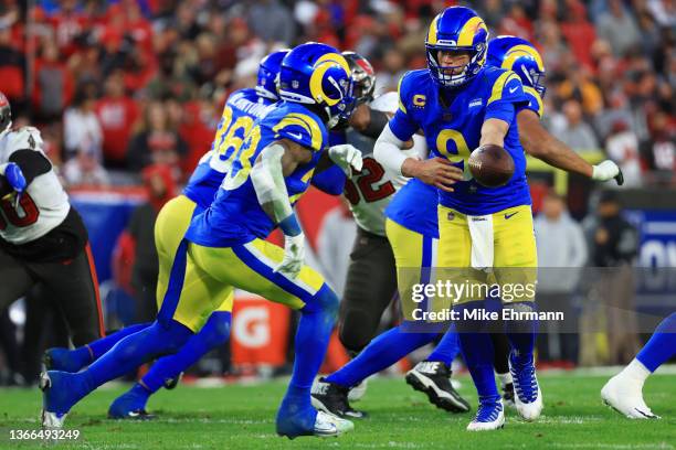 Matthew Stafford of the Los Angeles Rams hands the ball off to Cam Akers of the Los Angeles Rams in the fourth quarter in the NFC Divisional Playoff...