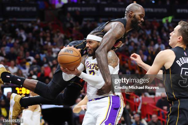 Carmelo Anthony of the Los Angeles Lakers is fouled by Dewayne Dedmon of the Miami Heat during the first half at FTX Arena on January 23, 2022 in...