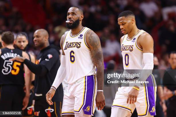 LeBron James and Russell Westbrook of the Los Angeles Lakers react against the Miami Heat during the first half at FTX Arena on January 23, 2022 in...