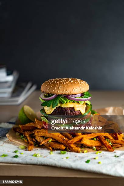 homemade plant based burger with sweet potato fries around. vegan. - plant based diet stock pictures, royalty-free photos & images