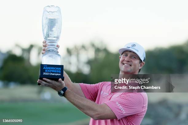Hudson Swafford celebrates with the winner's trophy after winning The American Express at the Stadium Course at PGA West on January 23, 2022 in La...