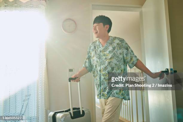 a man enjoying vacation at hotel - groove stockfoto's en -beelden