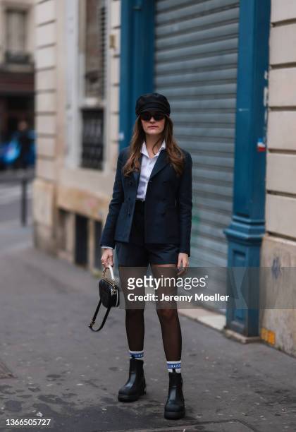 Nathalie Larche wearing full black and white Dior look during Paris Fashion Week on January 20, 2022 in Paris, France.