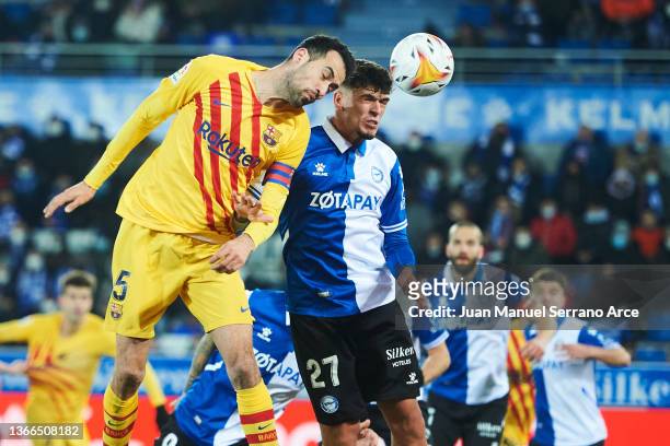 Javi Lopez of Deportivo Alaves battles for possession with Sergio Busquets of FC Barcelona during the LaLiga Santander match between Deportivo Alaves...
