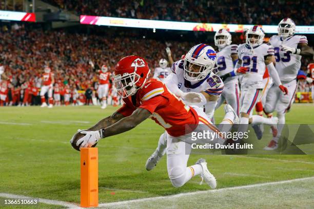 Mecole Hardman of the Kansas City Chiefs dives to score a 25 yard touchdown against Micah Hyde of the Buffalo Bills during the third quarter in the...