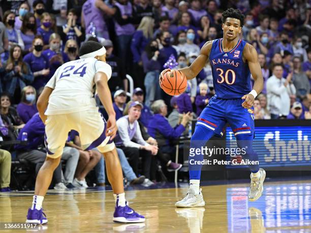Ochai Agbaji of the Kansas Jayhawks brings the ball up court during the first half against Nijel Pack of the Kansas State Wildcats at Bramlage...