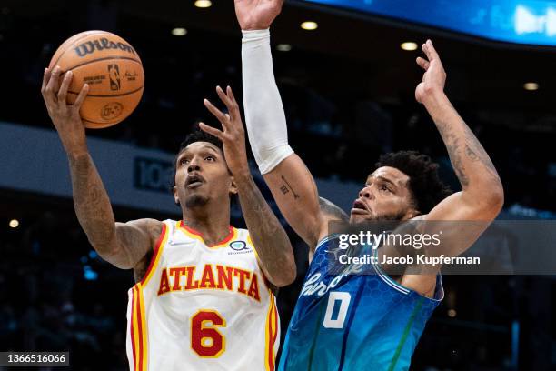 Lou Williams of the Atlanta Hawks drives to the basket while guarded by Miles Bridges of the Charlotte Hornets in the third quarter during their game...