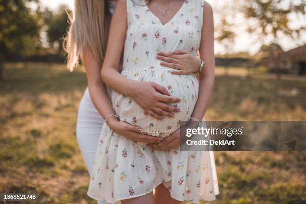 close-up of a pregnant lesbian woman and her girlfriend - pregnant couple stock pictures, royalty-free photos & images