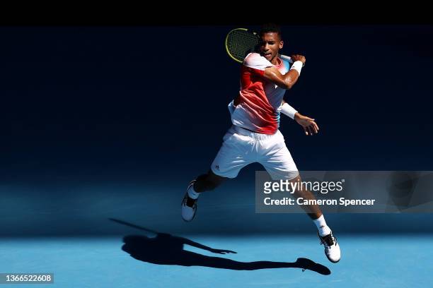 Felix Auger-Aliassime of Canada plays a forehand in his fourth round singles match against Marin Cilic of Croatia during day eight of the 2022...