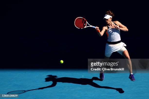 Alize Cornet of France plays a forehand in her fourth round singles match against Simona Halep of Romania during day eight of the 2022 Australian...
