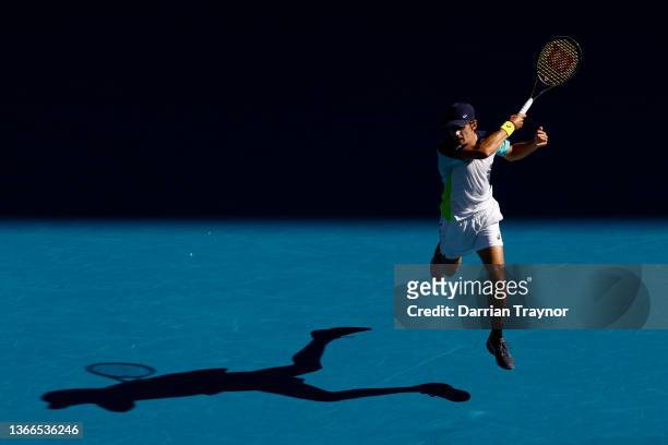 Alex De Minaur of Australia plays a forehand in his fourth round singles match against Jannik Sinner of Italy during day eight of the 2022 Australian...