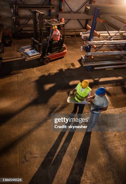 above view of a working day in industrial building. - metal factory stockfoto's en -beelden