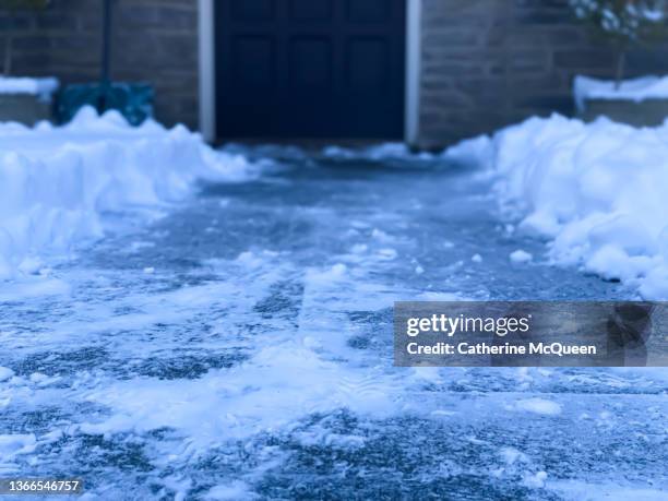 view from front porch steps of shoveled path to front door after snowstorm - pedestrian walkway stock pictures, royalty-free photos & images