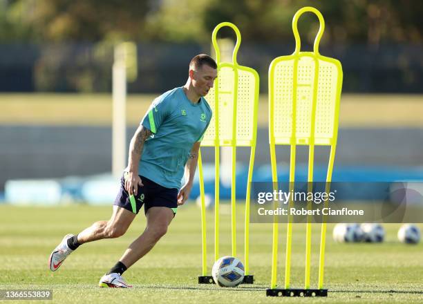 Mitchell Duke of Australia runs with the ball during an Australian Socceroos training session at Lakeside Stadium on January 24, 2022 in Melbourne,...