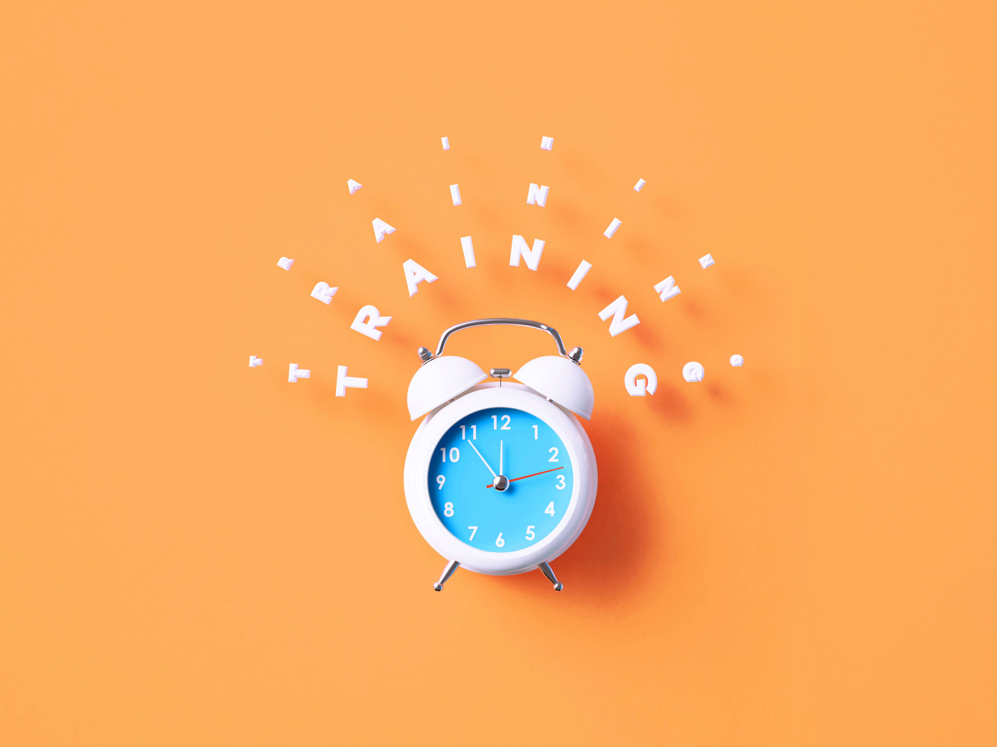 Training Message Sitting Above White Alarm Clock On Orange Background Training Message Sitting Above White Alarm Clock On Orange Background