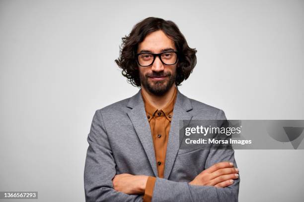confident male entrepreneur against white background - brown blazer stock pictures, royalty-free photos & images