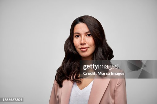 Happy Mixed Race Female Brunette CEO Wearing Pink Blazer. Happy Mixed Race Female Brunette CEO Wearing Pink Blazer.