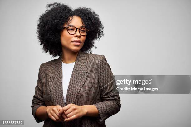 confident african american businesswoman against white background - female business executives stock-fotos und bilder