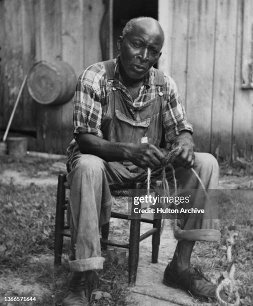 A Man Sits On A Chair Supported By A Rope Person Holding Rope Photos and Premium High Res Pictures - Getty Images