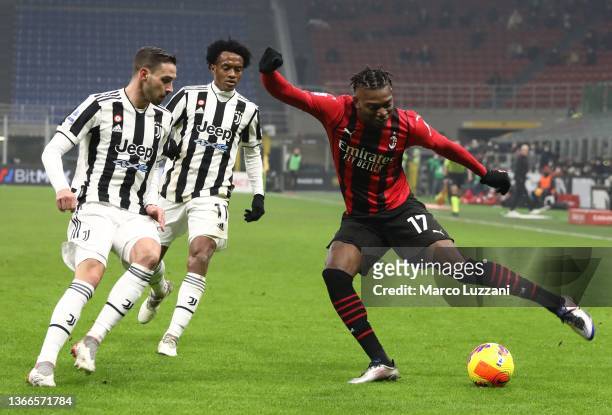 Rafael Leao of AC Milan is challenged by Mattia De Sciglio of Juventus FC during the Serie A match between AC Milan and Juventus at Stadio Giuseppe...