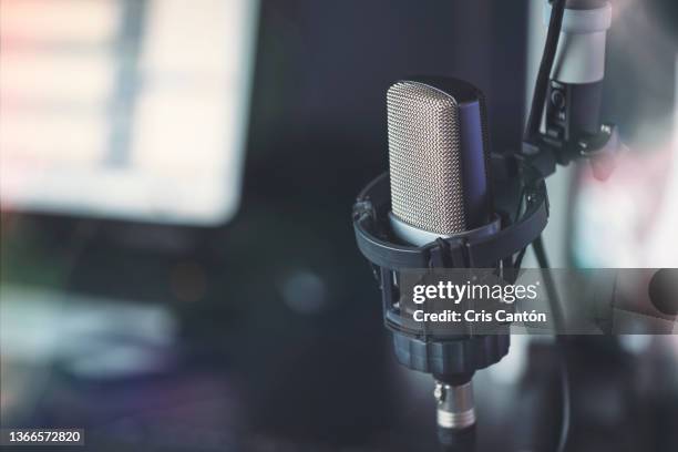 close up of microphone in radio broadcast studio - colour microphone stock-fotos und bilder