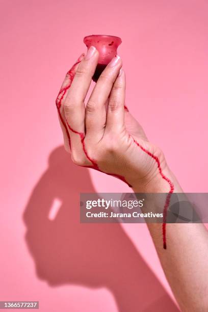 a woman's hand with a menstrual cup - period bildbanksfoton och bilder