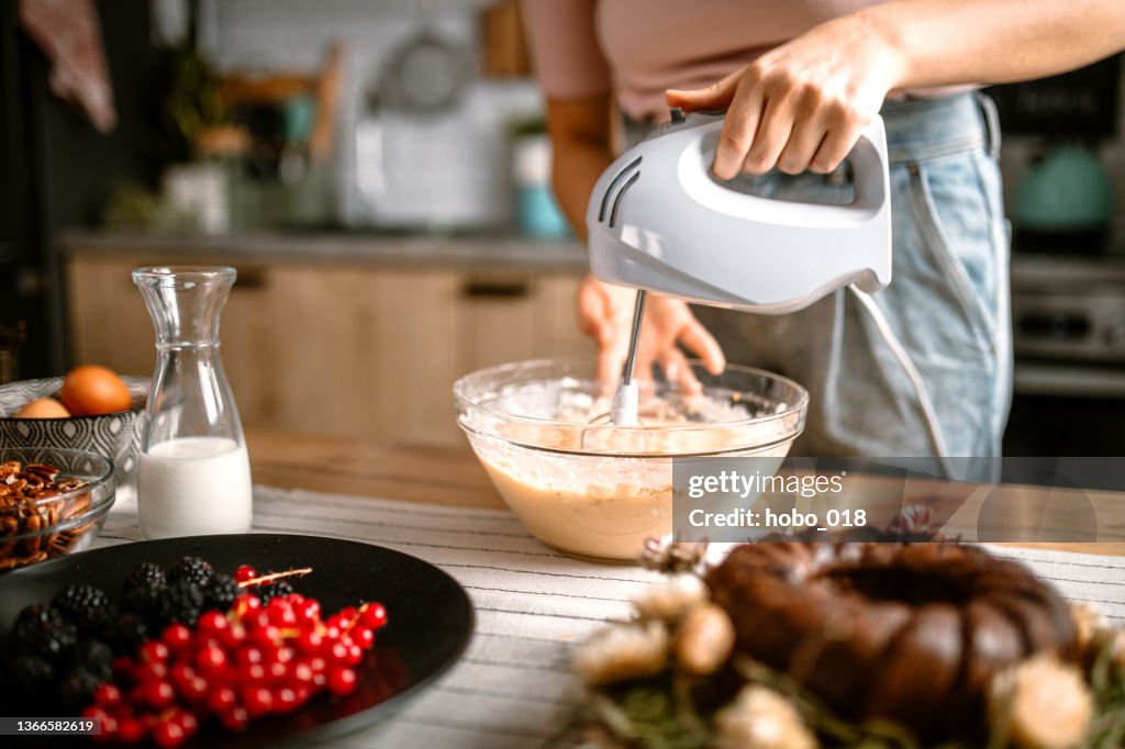 Mixing cake batter with electric mixer in the kitchen