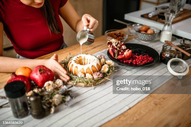 finishes cake with melted white chocolate - easter cake stock pictures, royalty-free photos & images