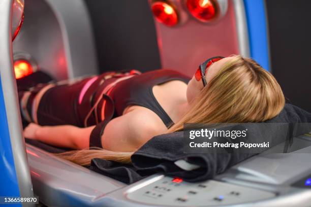 slimming treatment in infra red capsule - infrared lamp stock pictures, royalty-free photos & images